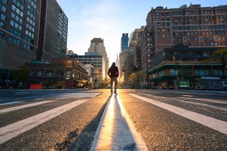 accenture One person crossing a junction in Manhattan at sunrise, New York City